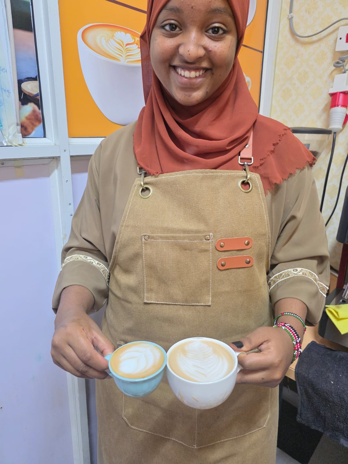 female student holding coffee with design2